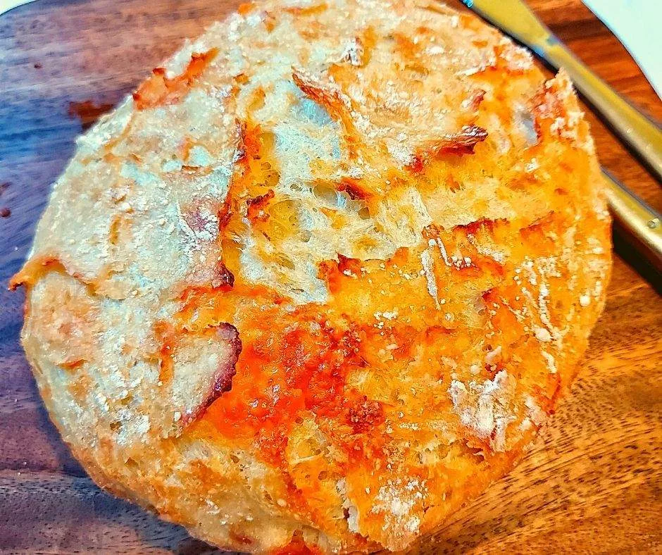 Crusty artisan cheese bread on a cutting board