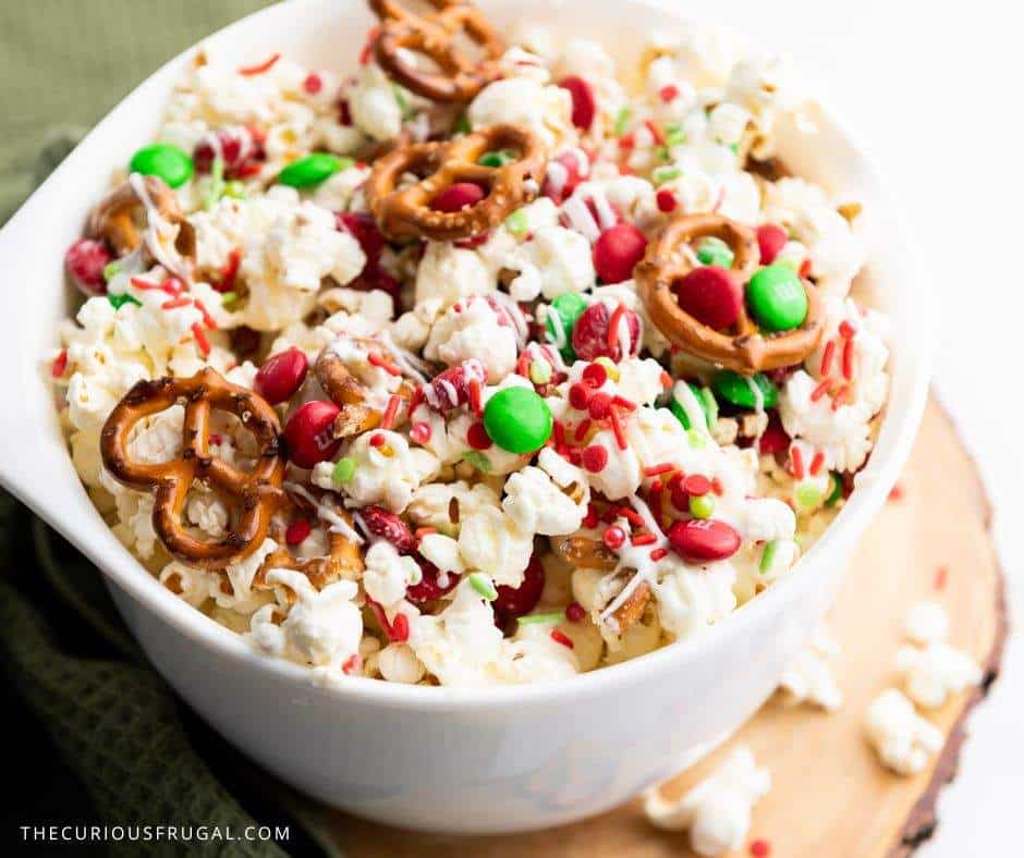 Make this easy Christmas popcorn for your next holiday movie night or party! This sweet and salty Christmas snack mix is loaded with chocolate, candy, and festive sprinkles — the perfect holiday treat for gifting or snacking. A quick Christmas recipe idea everyone will love!